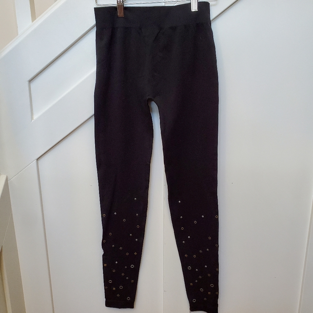 Black stretch leggings with metal rivets and studs